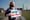 A constituent holds a Vote Uncommitted sign outside a voting location in Michigan.