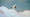 A Boeing 787 Dreamliner flying above a bank of clouds with the blue sky above.