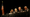 Several judges hear oral arguments at a long table with the American flag behind them.