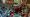 In a composite image, a humanoid robot is overlaid on the scene of a protest with American flags waving.